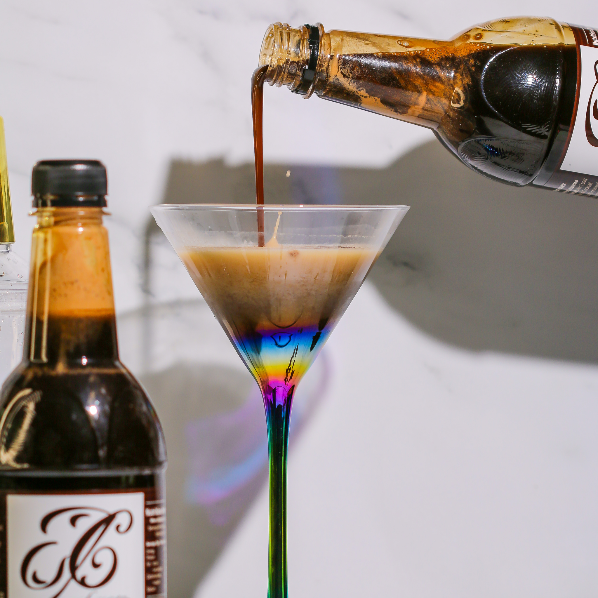 espresso martini syrup pouring into martini glass